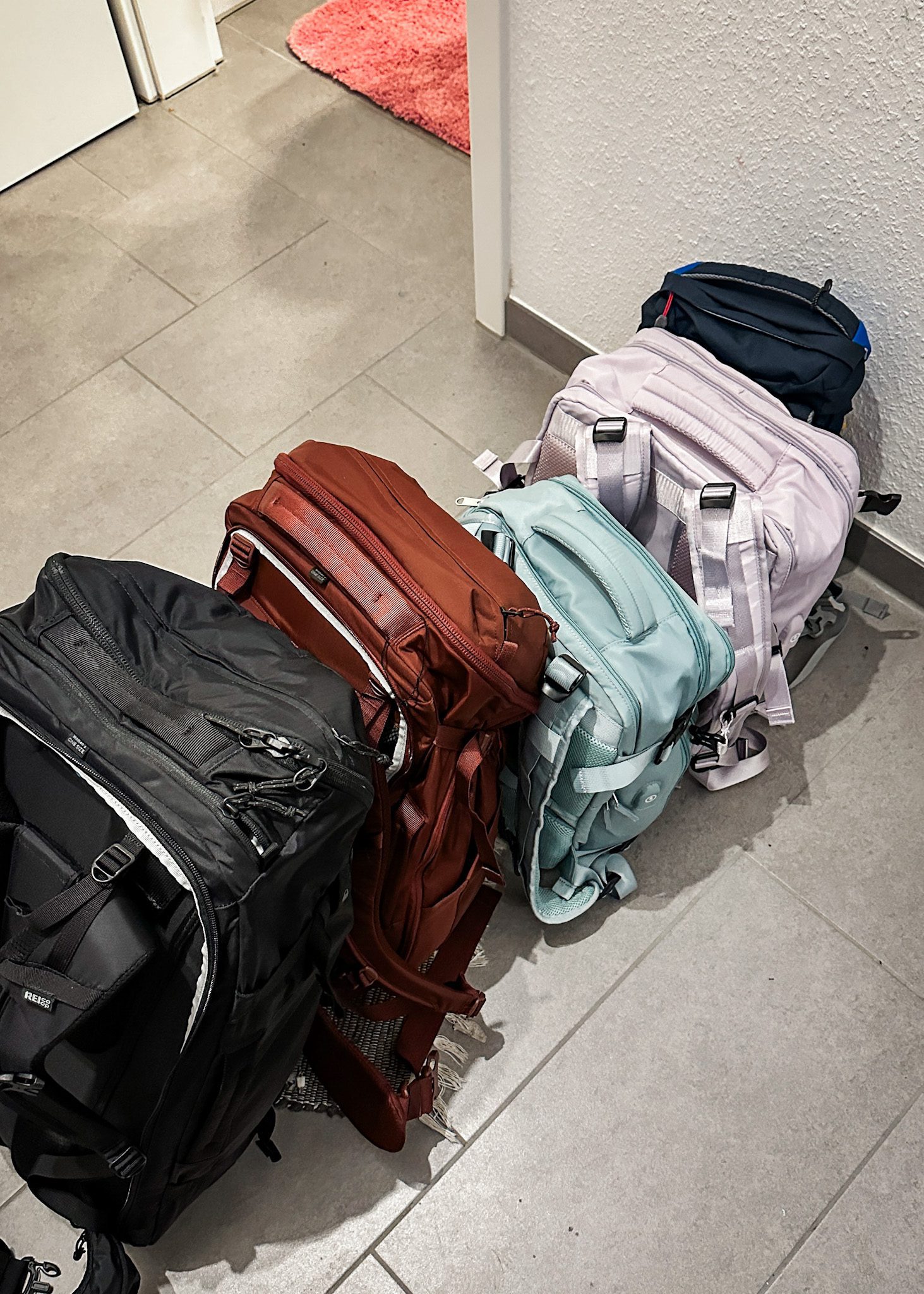 the best travel bags for Europe all lined up in a row ready for their next trip